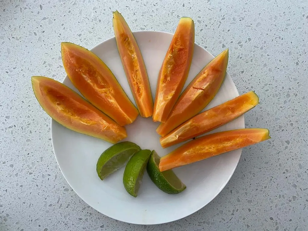 papaya and lime on a plate